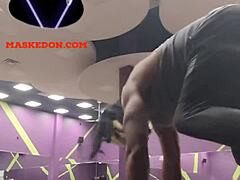 Masked woman exercises solo at the gym